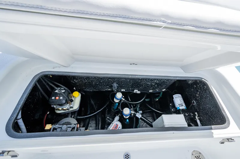 Slide: The Image of 2026 Yellowfin 24 Bay CE boat compartment with mechanical components and wiring. - 27