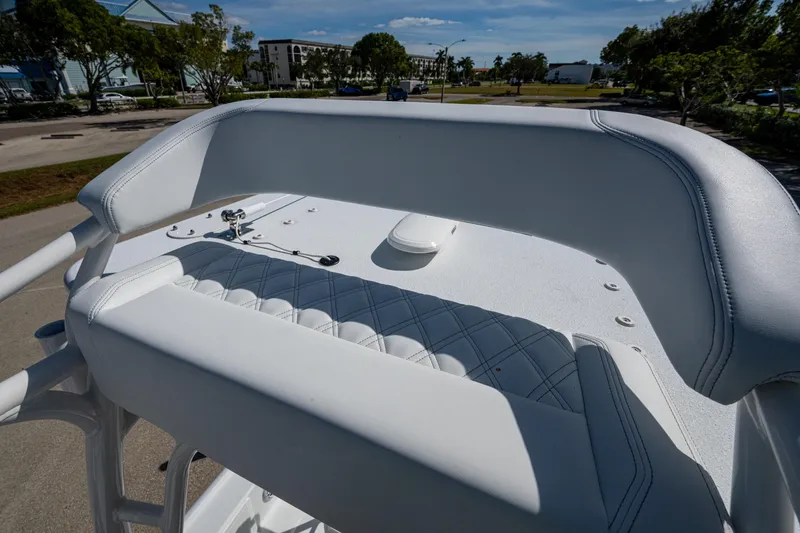Slide: The Image of 2026 Yellowfin 24 Bay CE boat with white cushioned seating and sleek design. - 9