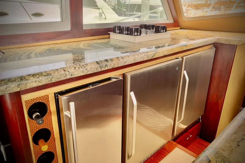 Slide: The Image of 1984 Egg Harbor 48' Flybridge interior with granite countertop, stainless steel appliances, and wine storage. - 10