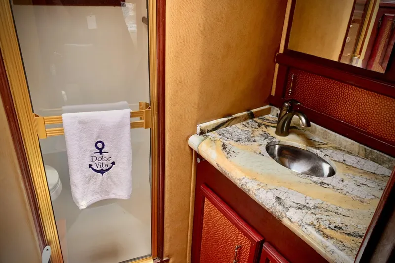 Slide: The Image of Luxurious bathroom in 1984 Egg Harbor 48' Flybridge yacht with marble countertop and elegant fixtures. - 12