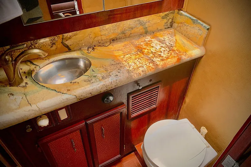 Slide: The Image of Luxurious bathroom in 1984 Egg Harbor 48' Flybridge yacht with marble countertop and modern fixtures. - 14