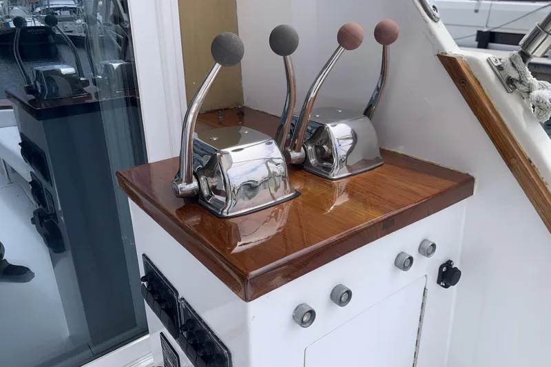 Slide: The Image of Control levers on 1984 Egg Harbor 48' Flybridge boat, polished wood and chrome finish. - 18