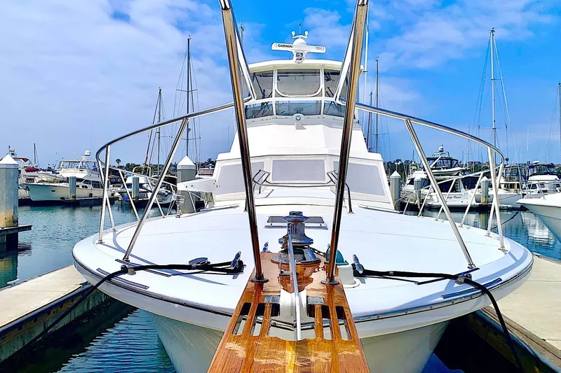 Slide: The Image of 1984 Egg Harbor 48' Flybridge yacht docked at marina under blue sky. - 2