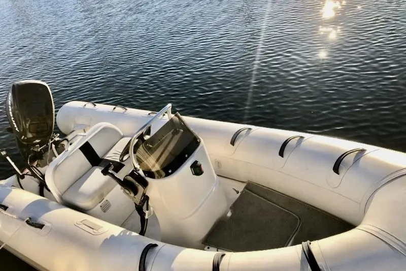 Slide: The Image of Inflatable boat on water, sunny day reflections, Egg Harbor 48' Flybridge, 1984 model. - 21