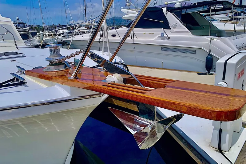 Slide: The Image of 1984 Egg Harbor 48' Flybridge yacht with polished anchor and wooden bow detail. - 3