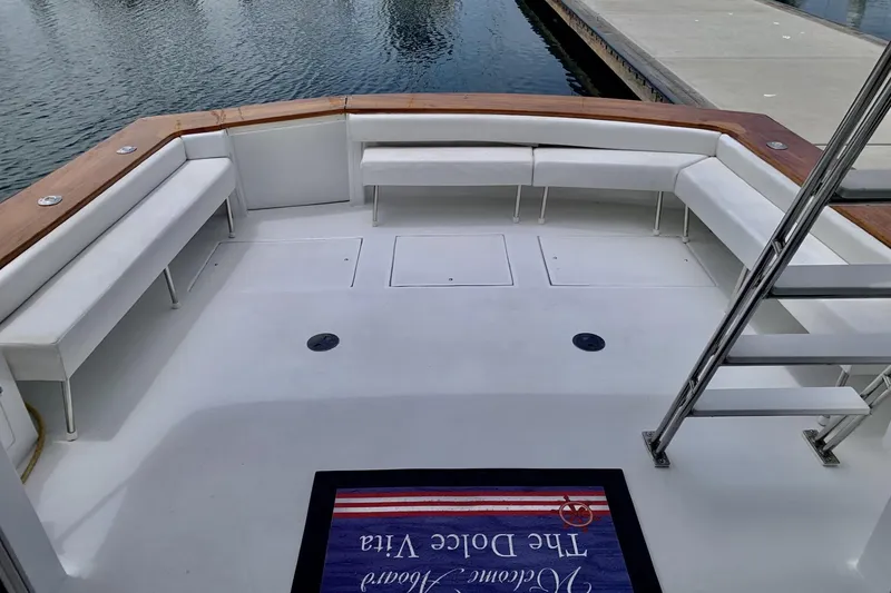 Slide: The Image of 1984 Egg Harbor 48' Flybridge boat deck with white seating and wooden accents. - 4