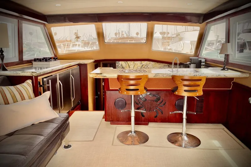 Slide: The Image of Luxurious interior of 1984 Egg Harbor 48' Flybridge yacht with bar and seating area. - 5