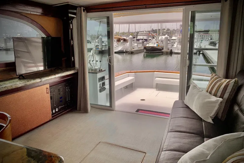 Slide: The Image of Interior of 1984 Egg Harbor 48' Flybridge yacht with marina view through sliding doors. - 8