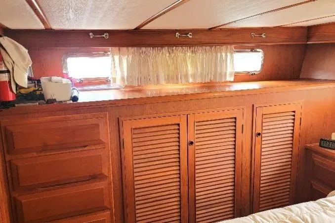 Slide: The Image of Interior of 1998 DeFever 44 Sundeck Trawler with wooden cabinets and small windows. - 12
