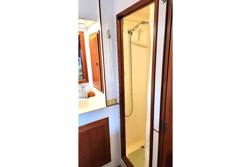 Slide: The Image of 1998 DeFever 44 Sundeck Trawler bathroom with shower and wooden cabinetry. - 14