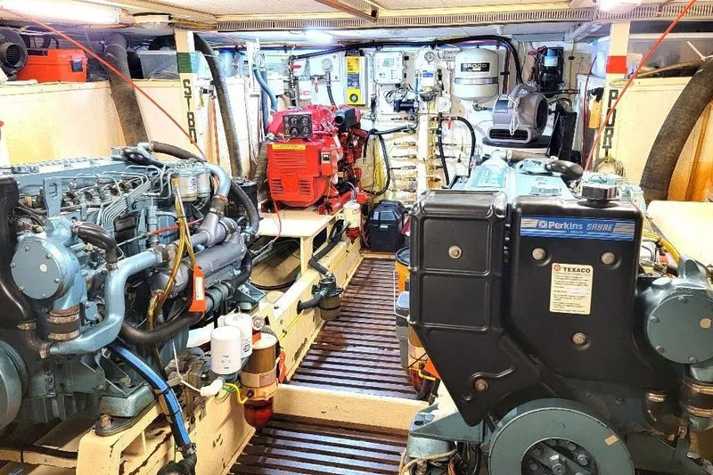 Slide: The Image of Engine room of 1998 DeFever 44 Sundeck Trawler with Perkins engines and equipment. - 23