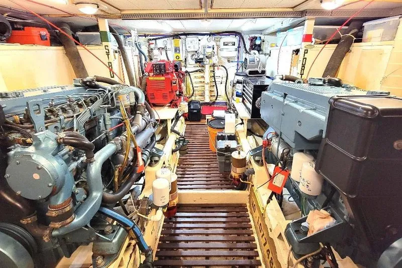 Slide: The Image of Engine room of 1998 DeFever 44 Sundeck Trawler, featuring dual engines and equipment. - 25