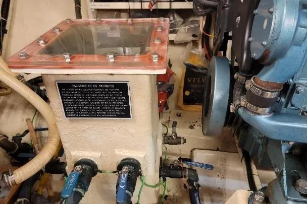 Slide: The Image of Engine room of 1998 DeFever 44 Sundeck Trawler with visible machinery and components. - 27