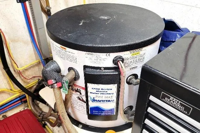 Slide: The Image of Water heater in 1998 DeFever 44 Sundeck Trawler engine room, featuring Hatteras 1700 Series. - 29