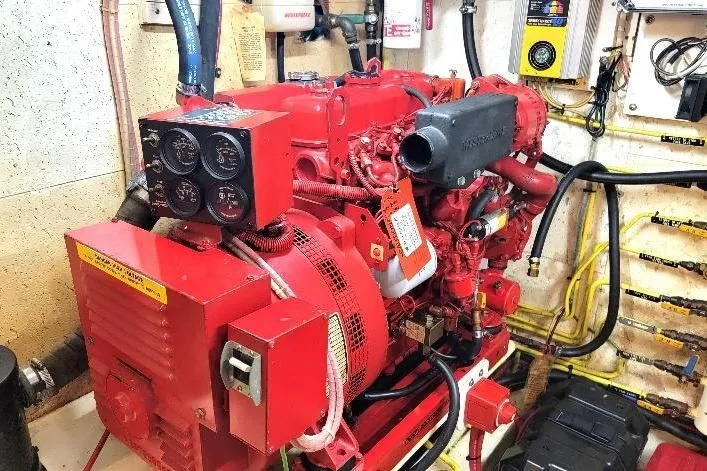 Slide: The Image of Engine room of 1998 DeFever 44 Sundeck Trawler with red marine engine. - 32