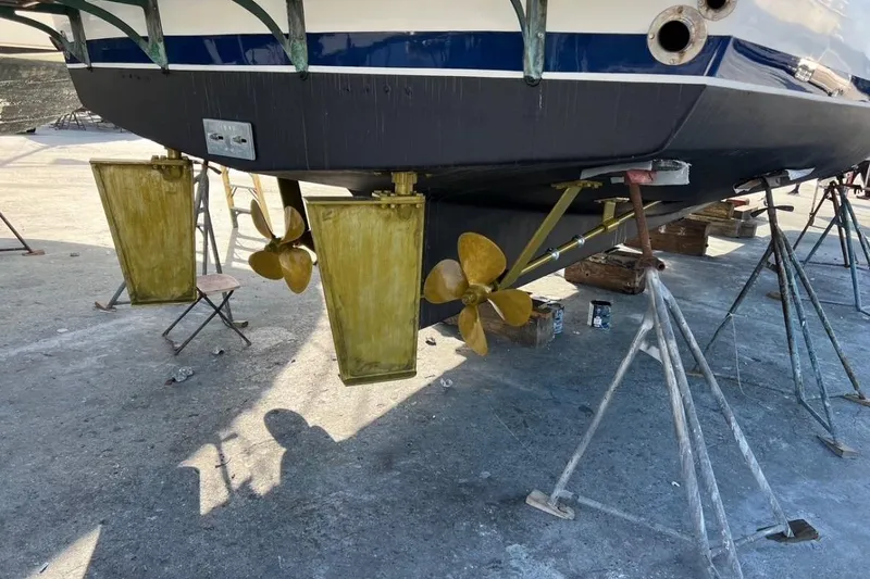 Slide: The Image of 1998 DeFever 44 Sundeck Trawler on dry dock, showing propellers and rudders. - 34