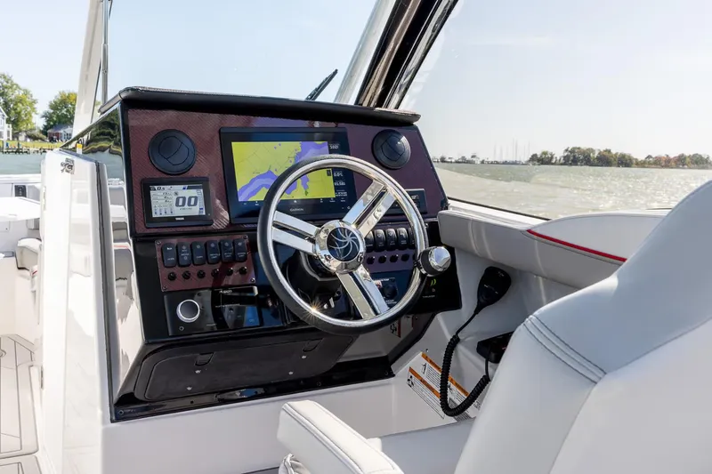 Slide: The Image of Manufacturer Provided Image: 2026 Solara S-250 DC boat dashboard with navigation screen and steering wheel. - 3