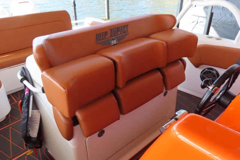Slide: The Image of Orange leather seating on a 2007 Deep Impact 36 boat interior. - 11