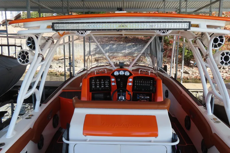 Slide: The Image of 2007 Deep Impact 36 boat cockpit with orange accents and advanced controls. - 23