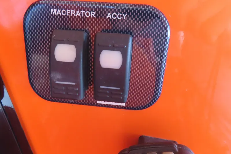 Slide: The Image of Control panel with macerator and accessory switches on 2007 Deep Impact 36 boat. - 28