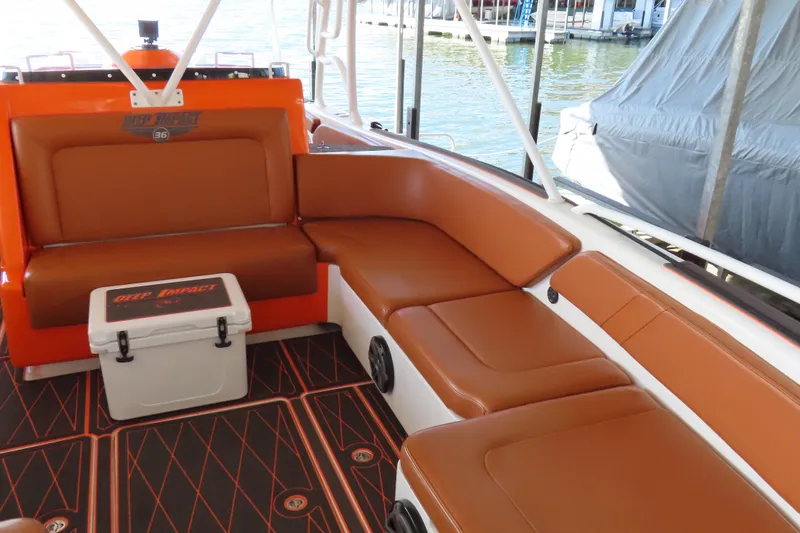 Slide: The Image of Interior of a 2007 Deep Impact 36 boat with brown seating and a branded cooler. - 8
