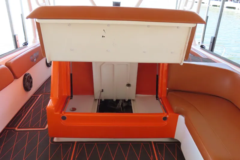 Slide: The Image of 2007 Deep Impact 36 boat interior with orange seating and storage compartment. - 9