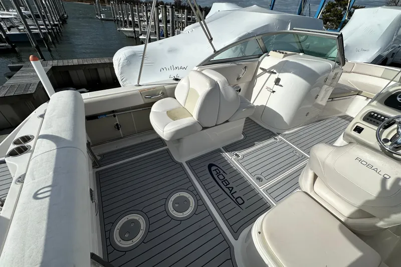 Slide: The Image of 2016 Robalo R227 Dual Console boat interior with seating and steering wheel. - 13
