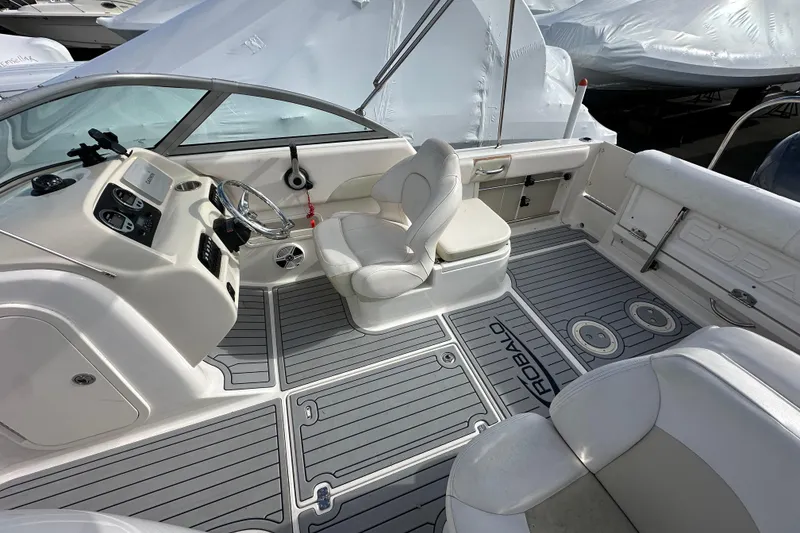 Slide: The Image of 2016 Robalo R227 Dual Console boat interior with steering wheel and seating. - 15