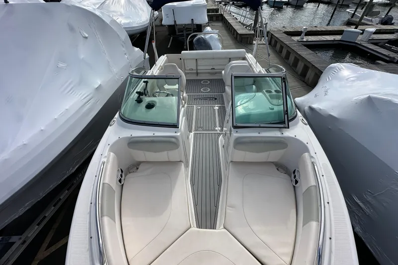 Slide: The Image of 2016 Robalo R227 Dual Console boat docked, featuring spacious seating and sleek design. - 17