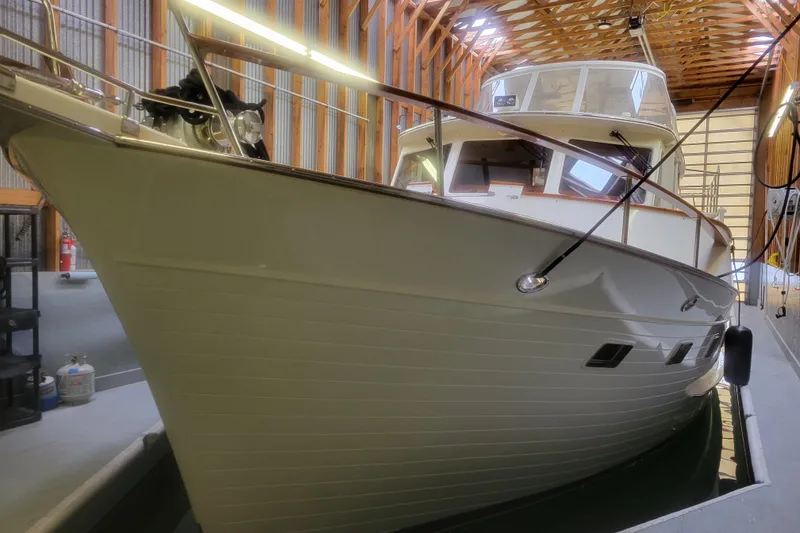 Slide: The Image of Large BoatHouse vessel docked in a wooden boathouse, showcasing sleek design and craftsmanship. - 11