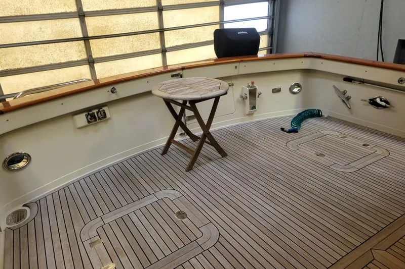 Slide: The Image of 2005 BoatHouse model interior with wooden deck and foldable table. - 8