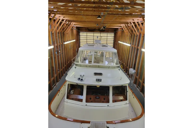 Slide: The Image of BoatHouse 2005 model in wooden boathouse, top view, well-lit interior. - 9