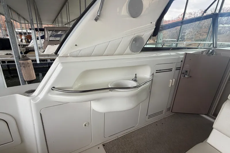 Slide: The Image of 1999 Sea Ray 400 Sundancer interior with sink and storage compartments. - 13