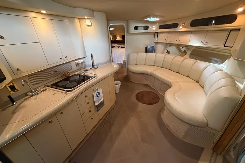 Slide: The Image of Luxurious interior of a 1999 Sea Ray 400 Sundancer yacht with kitchen and seating area. - 18