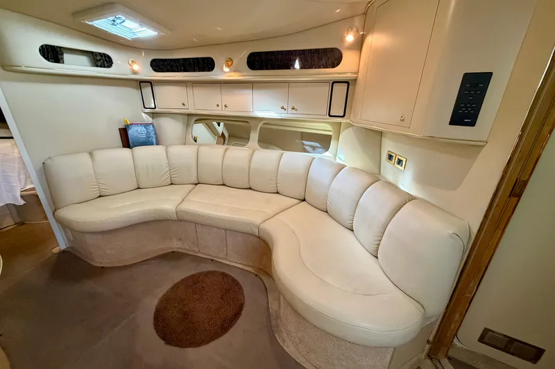 Slide: The Image of Luxurious interior of 1999 Sea Ray 400 Sundancer with curved leather seating. - 19