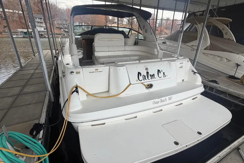 Slide: The Image of 1999 Sea Ray 400 Sundancer docked at Osage Beach, MO, with "Calm C's" nameplate. - 2
