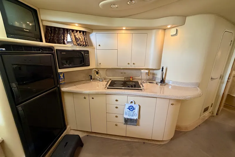 Slide: The Image of 1999 Sea Ray 400 Sundancer yacht kitchen with appliances and cabinetry. - 21
