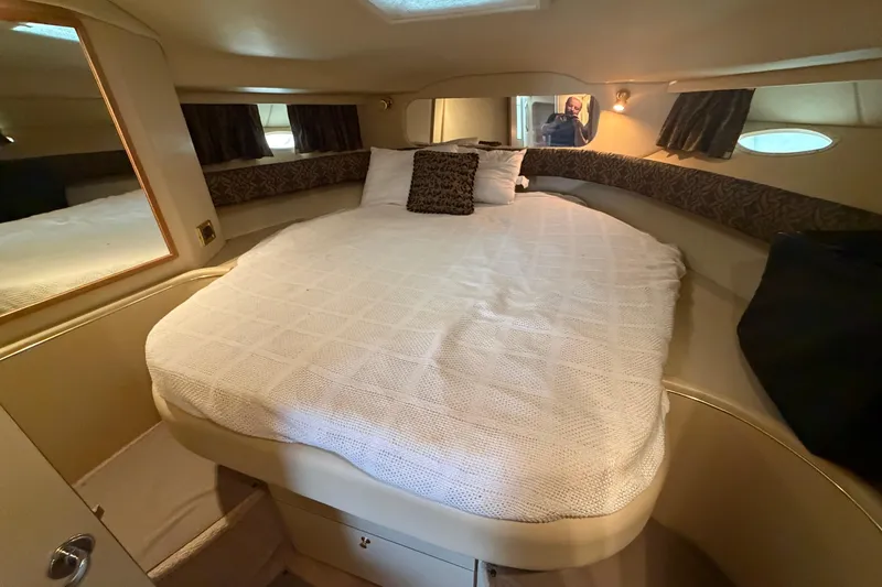 Slide: The Image of 1999 Sea Ray 400 Sundancer cabin with cozy bed and elegant interior design. - 22