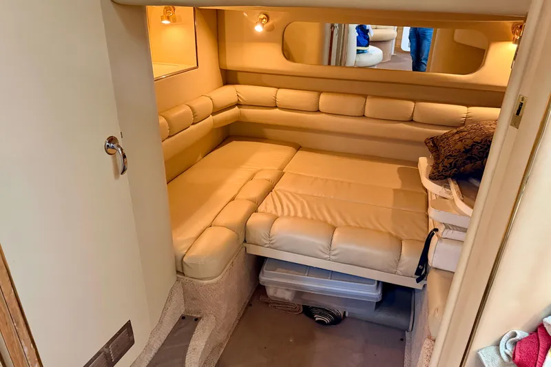Slide: The Image of 1999 Sea Ray 400 Sundancer cabin interior with beige leather seating and cozy lighting. - 28