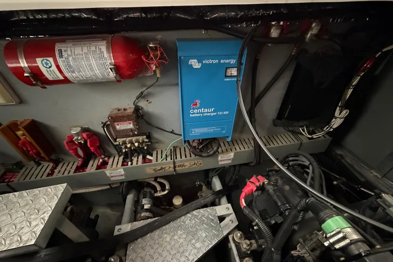 Slide: The Image of Engine room of 1999 Sea Ray 400 Sundancer with battery charger and fire extinguisher. - 34