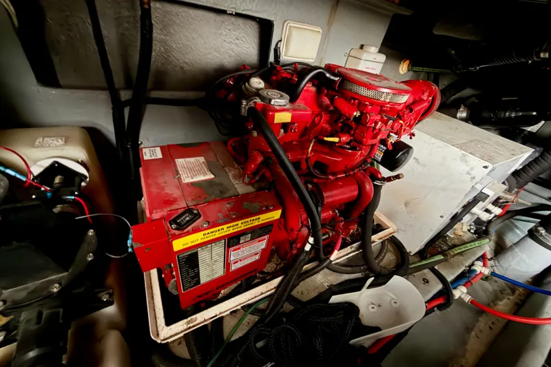 Slide: The Image of Engine room of 1999 Sea Ray 400 Sundancer with red machinery and wiring. - 35