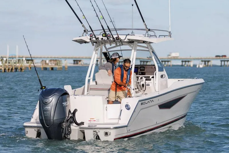 Slide: The Image of Manufacturer Provided Image: 2025 Solara S-250 CW boat on water, equipped for fishing, with two people onboard. - 1