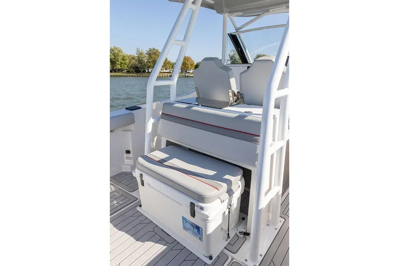 Slide: The Image of Manufacturer Provided Image: 2025 Solara S-250 CW boat interior with seating and storage on a sunny day. - 16