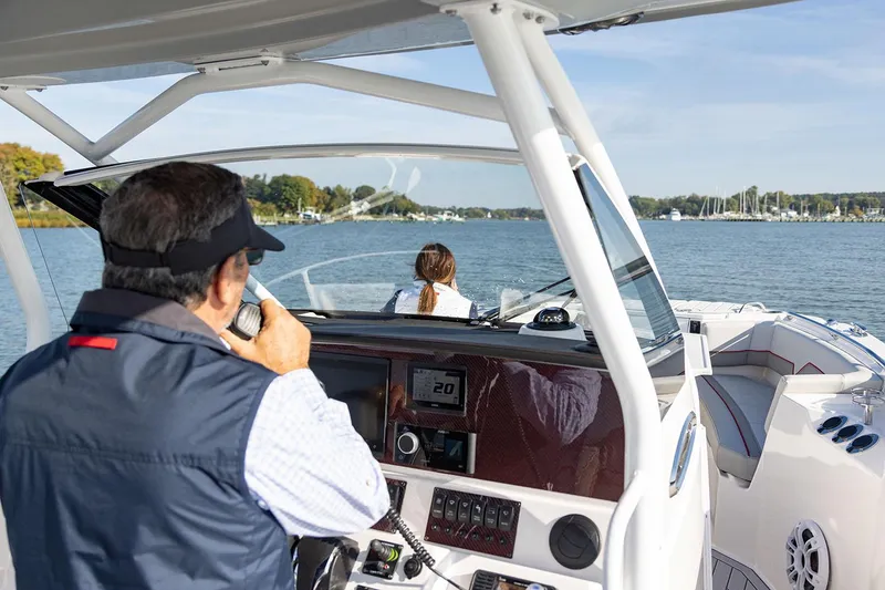 Slide: The Image of Manufacturer Provided Image: 2025 Solara S-250 CW boat cruising on a scenic lake with two passengers. - 5