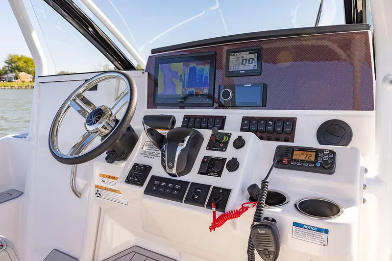 Slide: The Image of Manufacturer Provided Image: 2025 Solara S-250 CW boat dashboard with navigation screens and controls. - 7