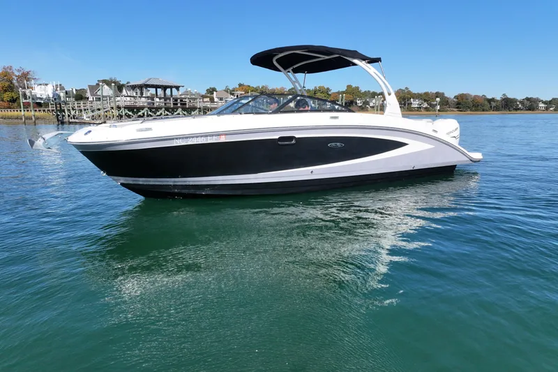 Slide: The Image of 2017 Sea Ray SDX 270 Outboard boat on calm water, clear sky background. - 1