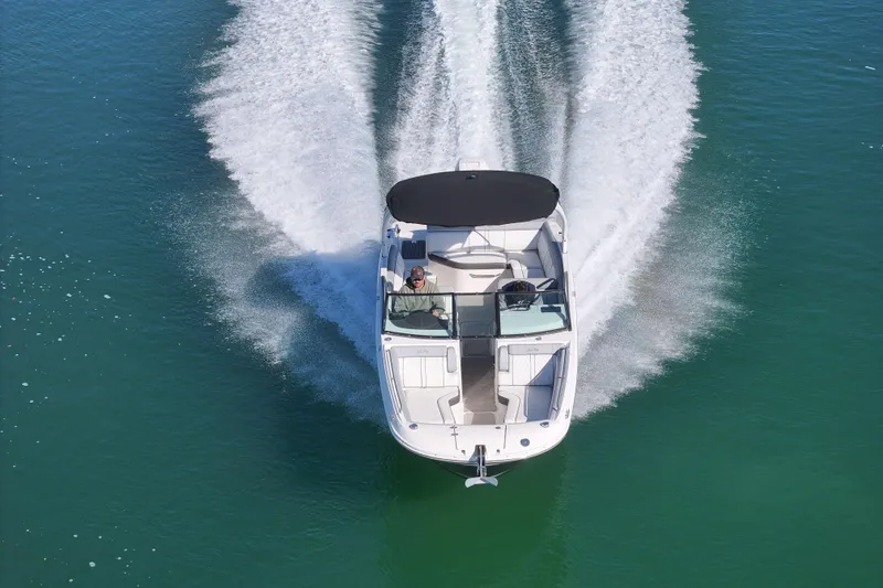 Slide: The Image of 2017 Sea Ray SDX 270 Outboard cruising on clear blue water, aerial view. - 10