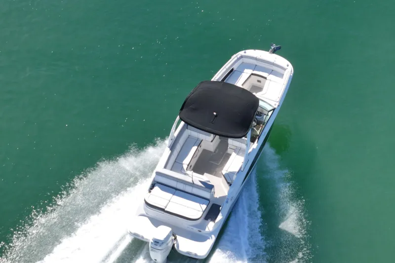 Slide: The Image of 2017 Sea Ray SDX 270 Outboard cruising on clear green water. - 11