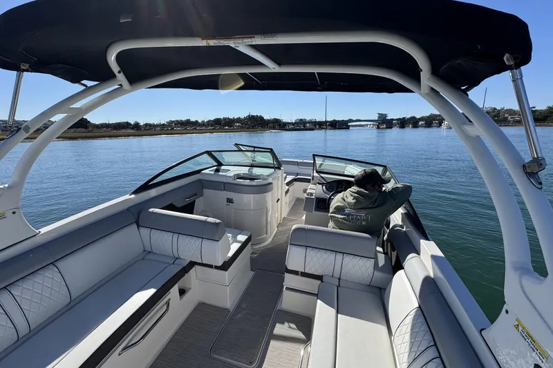 Slide: The Image of 2017 Sea Ray SDX 270 Outboard boat on calm water, featuring spacious seating and canopy. - 12