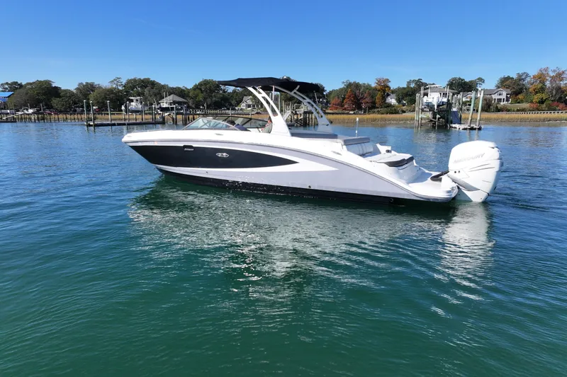 Slide: The Image of 2017 Sea Ray SDX 270 Outboard boat on calm water, clear sky background. - 2